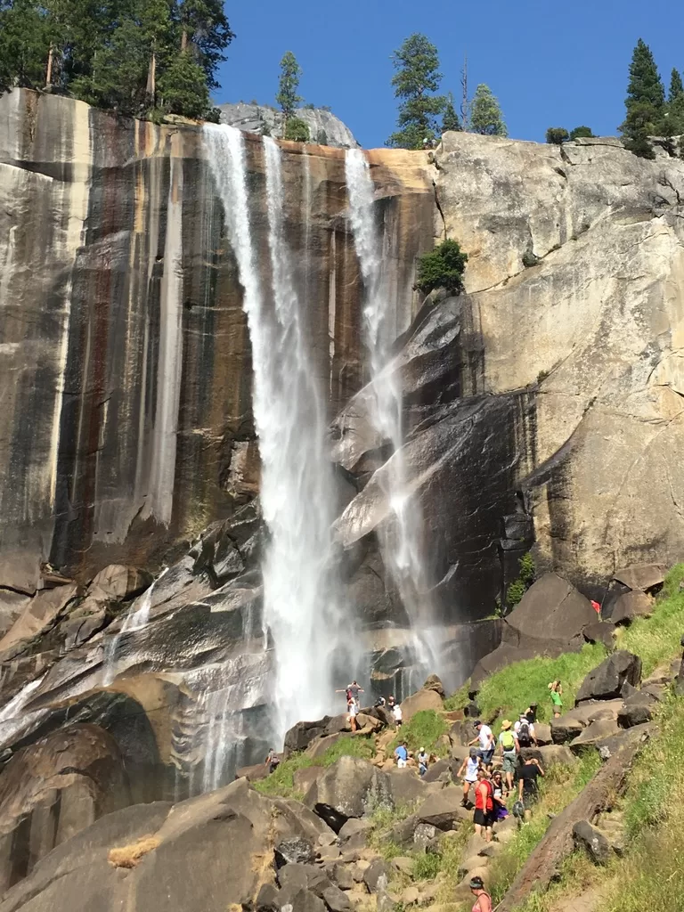 Crowds of people hiking the Mist Trail in Yosemite National Park. 