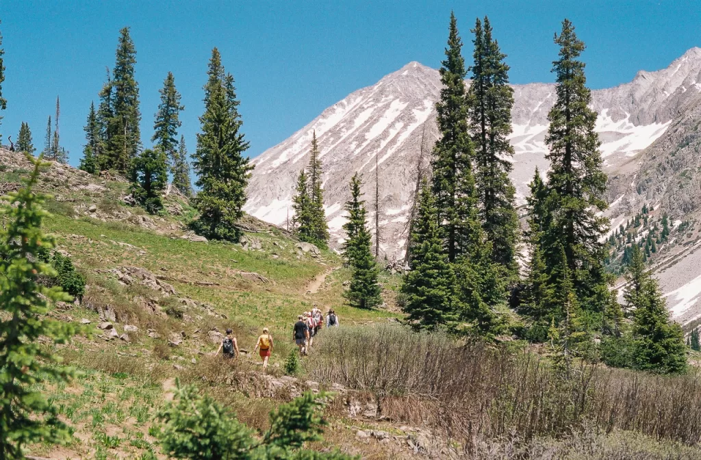 Friends hiking up toward a mountain in Colorado. 