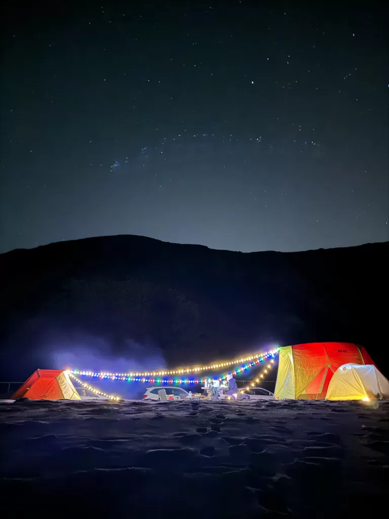 String lights strung between several tents and lit up while we cook dinner under the starts during our Point Mugu State Park camping trip. 