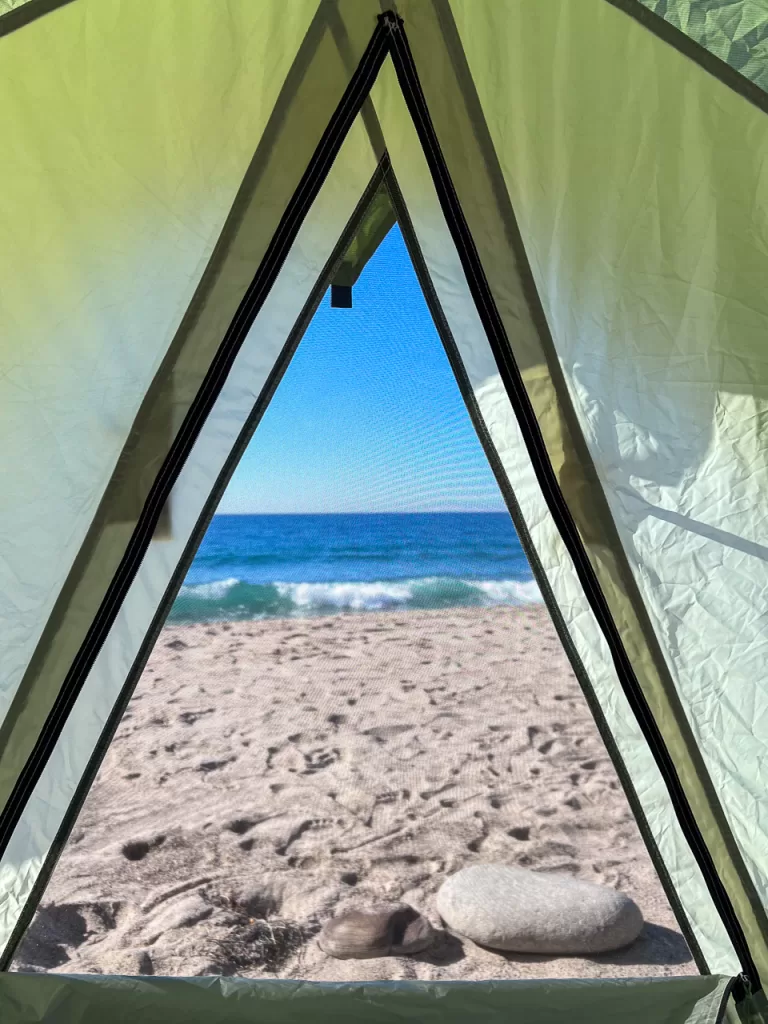 The Pacific Ocean viewed through a tent window. 