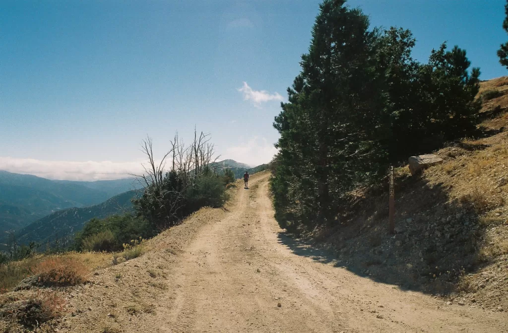 A hiker walking along a trail to Granite Mountain in the western San Gabriel Mountains. 