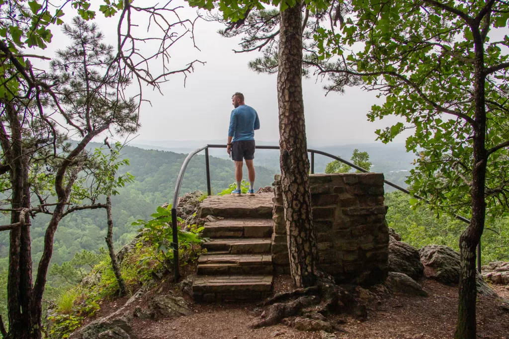 A person standing at a lookout on the Goat Rock Trail in Hot Springs National Park.