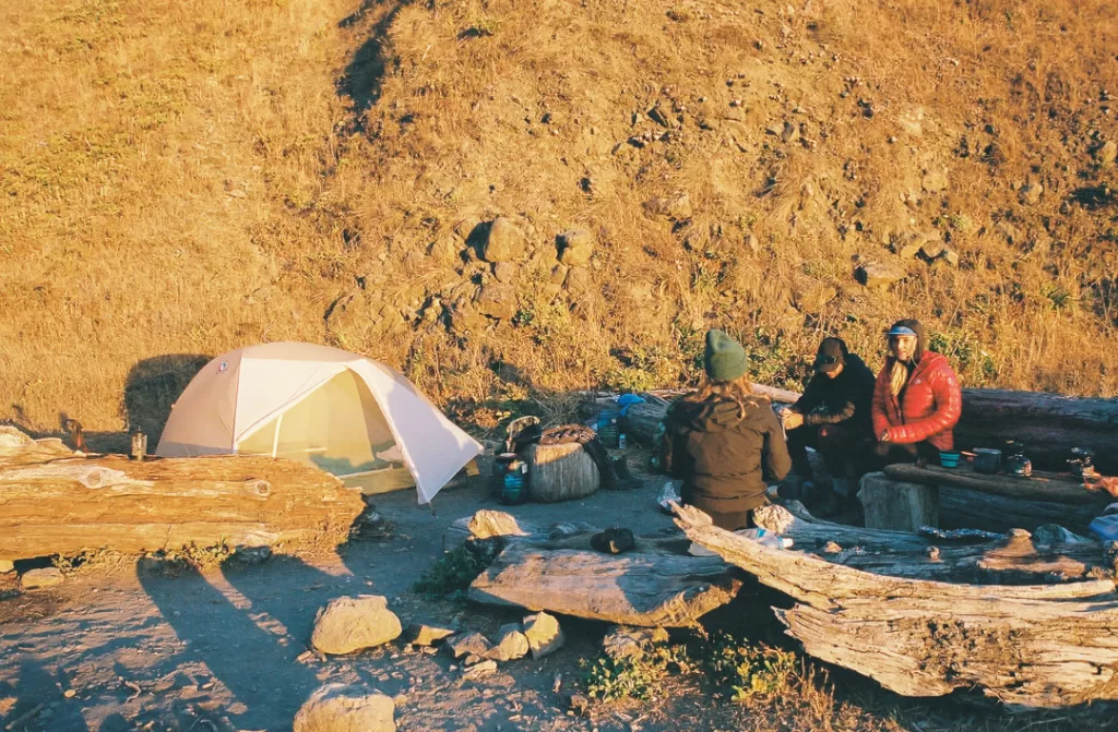 Hikers talking after setting up camp while hiking the lost coast trail. 