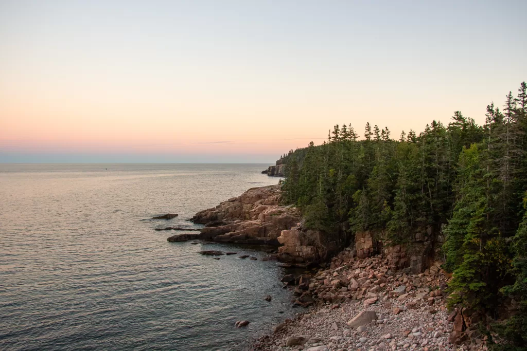 The rugged coastline of Acadia National Park at sunset.