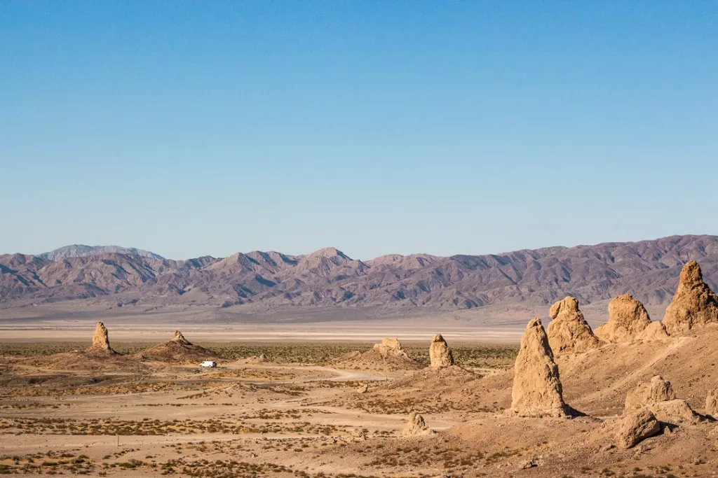 A van parked in the Mojave Desert. 