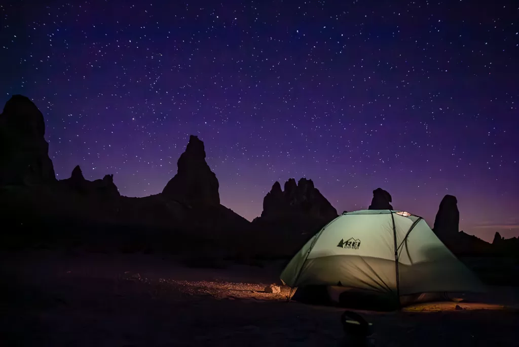 A tent at night in the desert. 