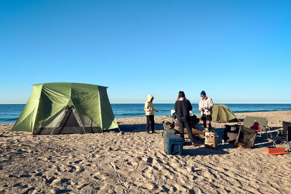 Friends camping on the beach.