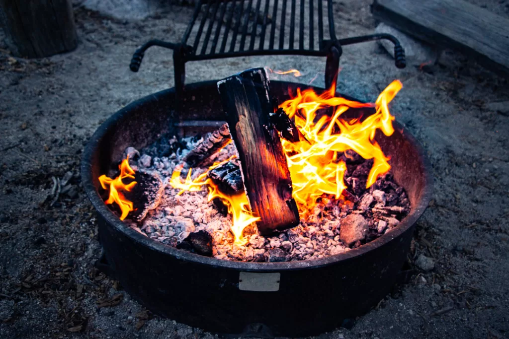 a campfire burning in a fire ring. 