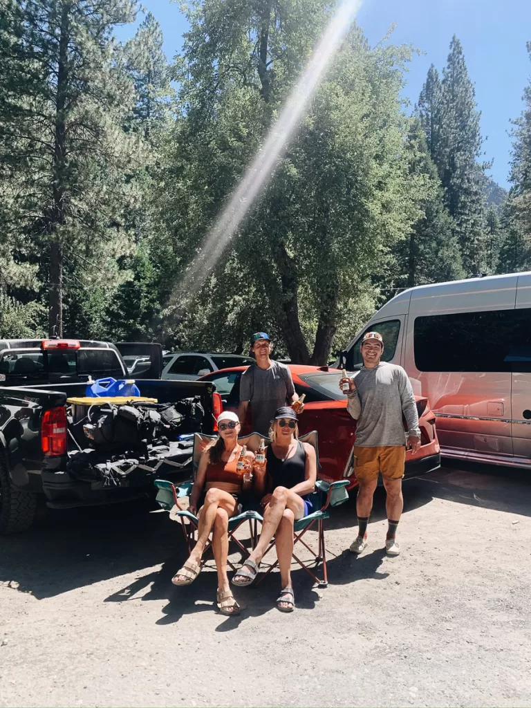 Hikers holding up a cold drink, following a good idea when learning how to hike, of packing a treat for after a long hike. 