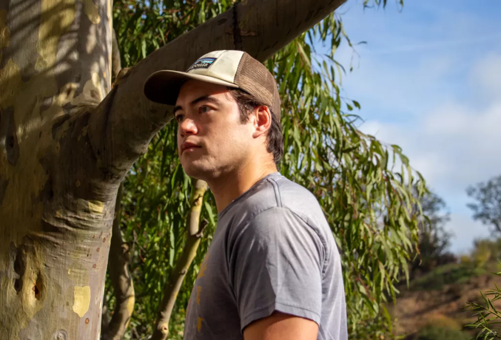 A person wearing a Patagonia P-6 logo trucker hat.