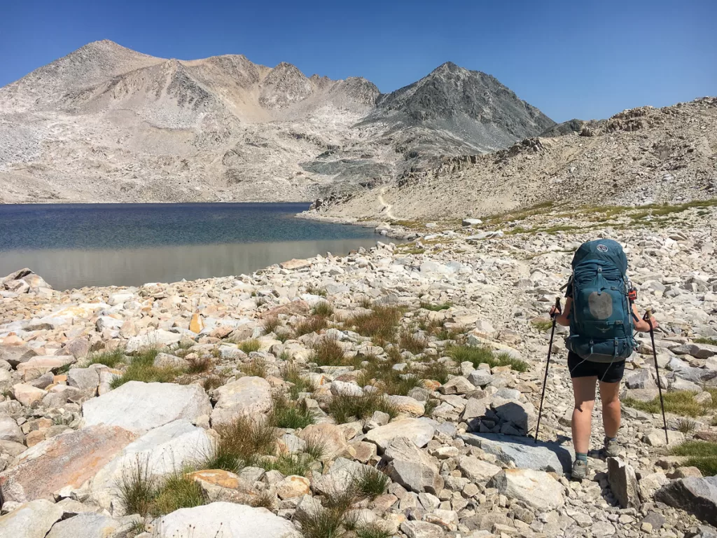 A hiker hiking in high altitude among the mountains. 