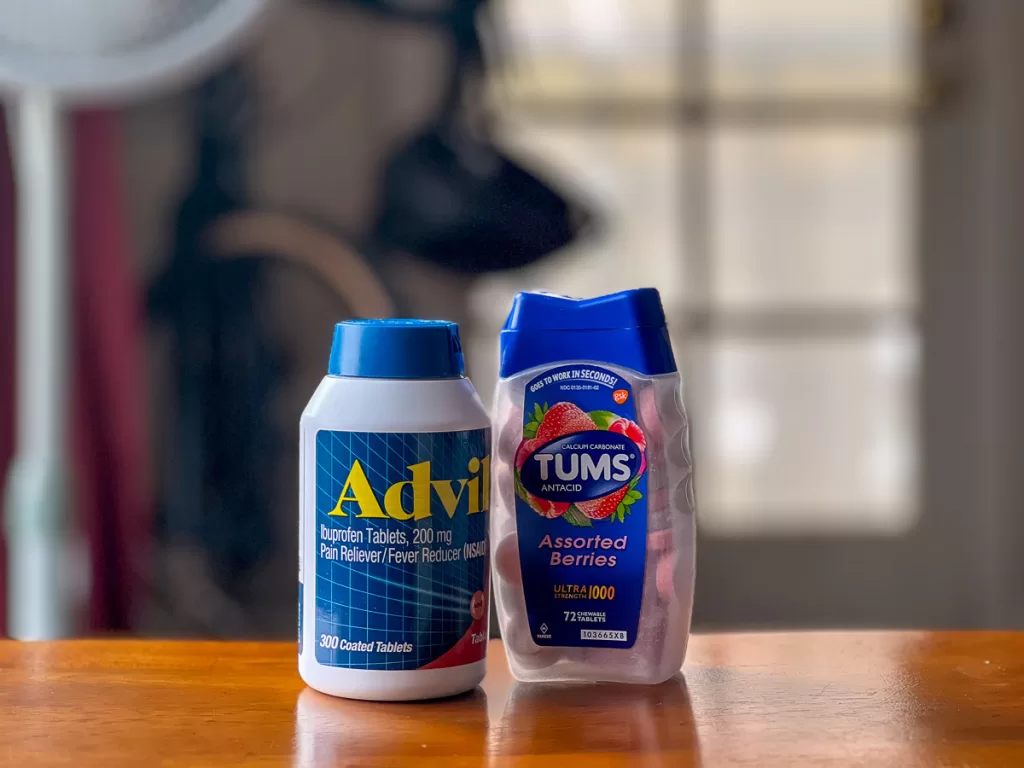 Advil and Tums bottles, two medications that are part of one of the most common backpacker mistakes of not bringing crucial over-the-counter medications. 