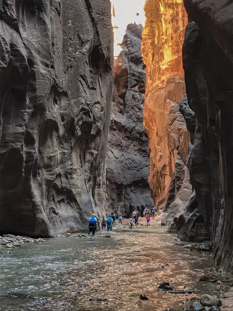 hiker walking the river as they hike the Narrows. 