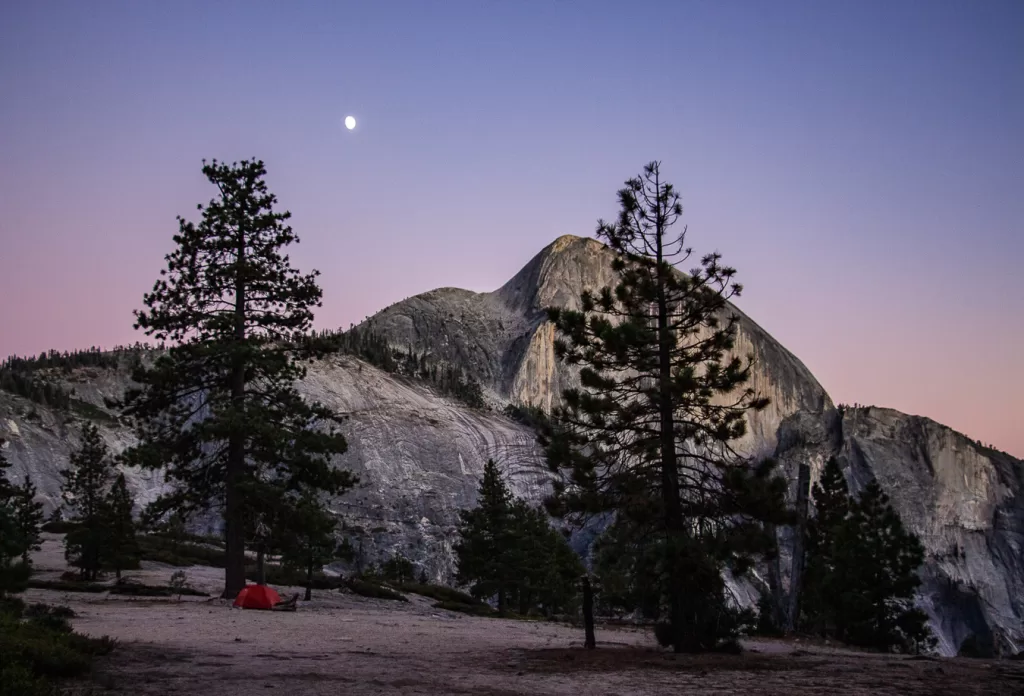 A tent and half dome in the distance.