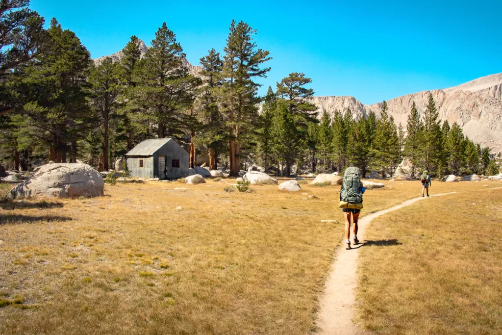 two people backpacking in the mountains as a way to spend more time outside.