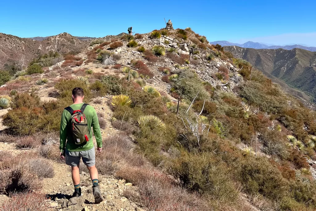 two hikers on top of a mountain.